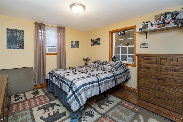 bedroom with dark wood-type flooring and cooling unit