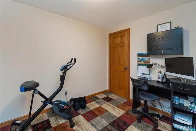 office space with dark wood-type flooring and baseboards