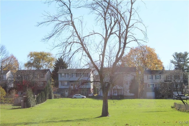 view of home's community with a yard