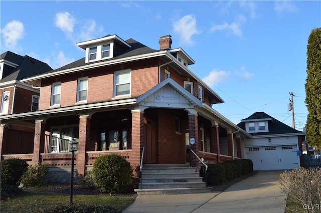 view of front facade featuring a porch, an attached garage, brick siding, driveway, and a chimney