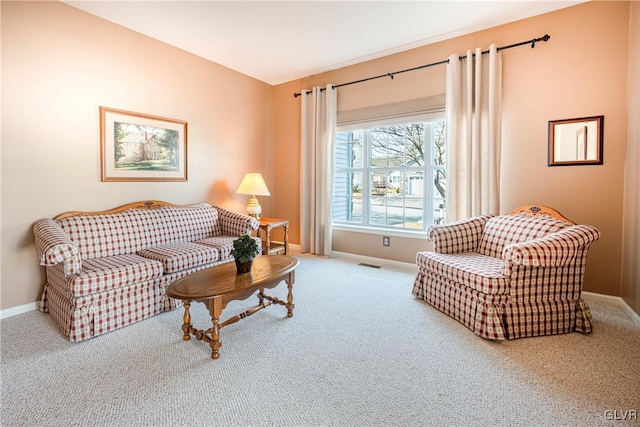 sitting room with carpet flooring, visible vents, and baseboards