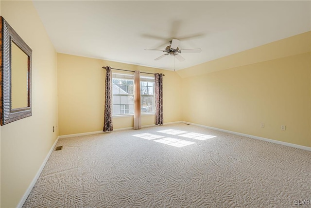 spare room with light carpet, baseboards, and a ceiling fan