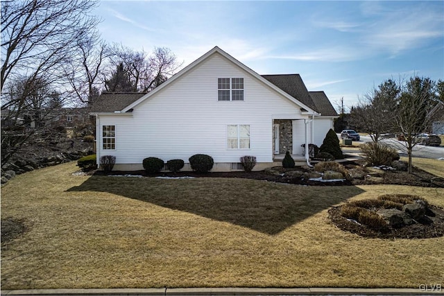 view of property exterior with a yard