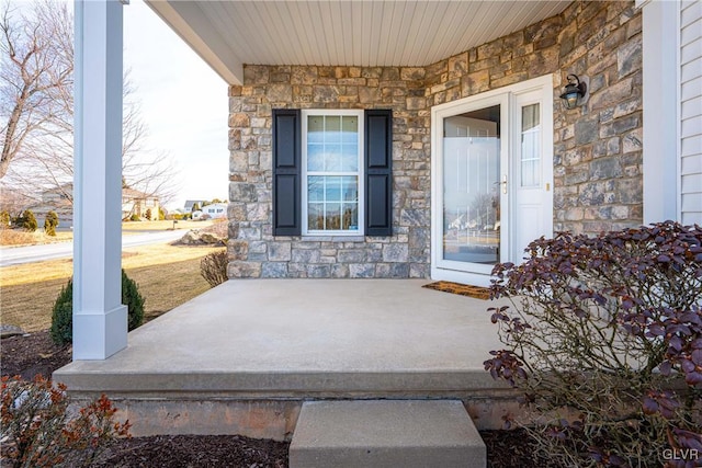 property entrance featuring stone siding