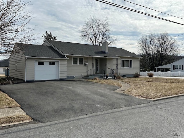 single story home featuring driveway, an attached garage, a chimney, and roof with shingles