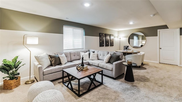 living area featuring recessed lighting, baseboards, and light colored carpet