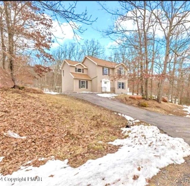 traditional home with aphalt driveway