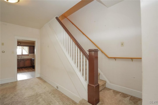 staircase with carpet floors and baseboards