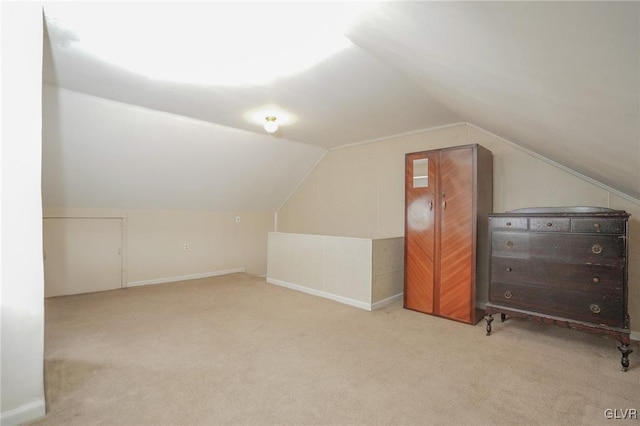 bonus room with light carpet and lofted ceiling