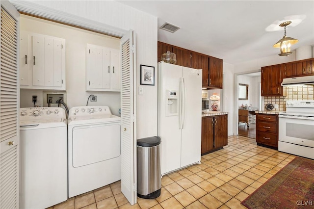 interior space with visible vents, light tile patterned floors, cabinet space, and washer and dryer