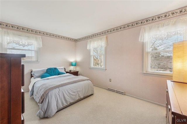 bedroom featuring carpet floors, multiple windows, and visible vents