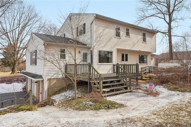 rear view of property featuring a wooden deck