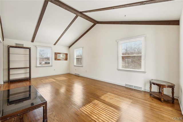 living room with vaulted ceiling with beams, wood finished floors, visible vents, and baseboards