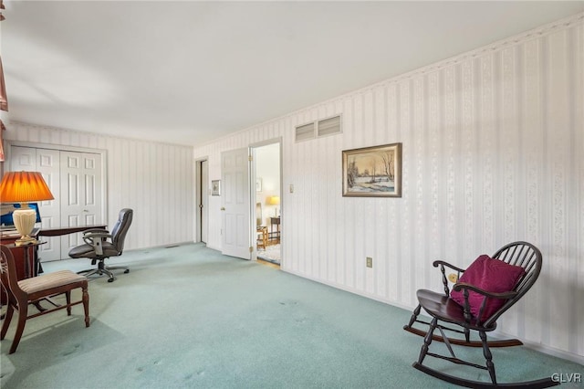 carpeted home office with visible vents and wallpapered walls