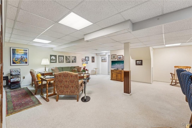 living area featuring a paneled ceiling and light colored carpet