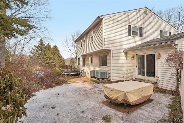 back of property featuring central AC and a deck