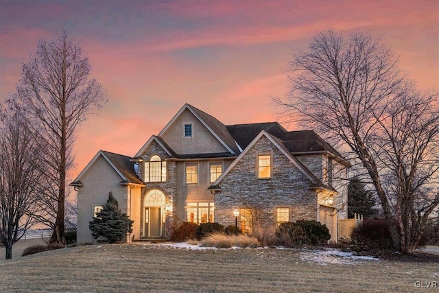 view of front of home with a front lawn and stone siding