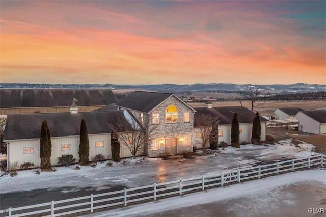 view of front of house with a fenced front yard and stone siding