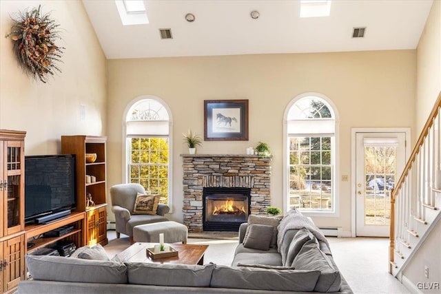 living room with stairway, visible vents, a wealth of natural light, and light carpet