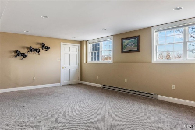 carpeted spare room featuring recessed lighting, a baseboard heating unit, and baseboards