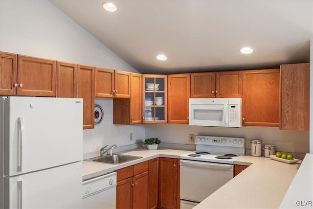 kitchen featuring glass insert cabinets, brown cabinets, white appliances, and light countertops