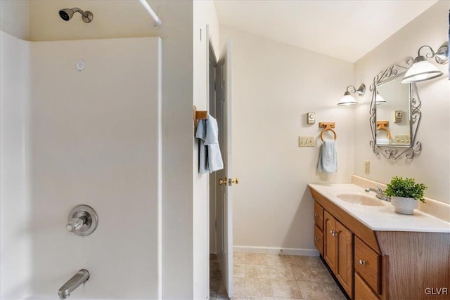 full bathroom featuring baseboards,  shower combination, and vanity