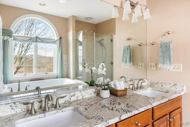 full bathroom featuring a sink, visible vents, a stall shower, and double vanity