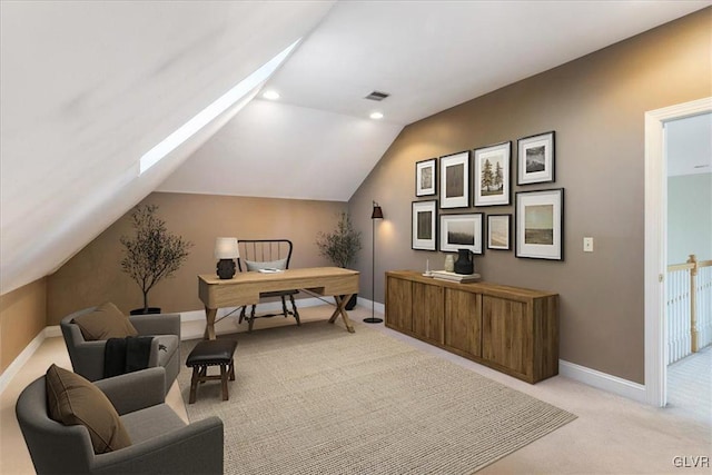 office area with lofted ceiling, light colored carpet, visible vents, and baseboards