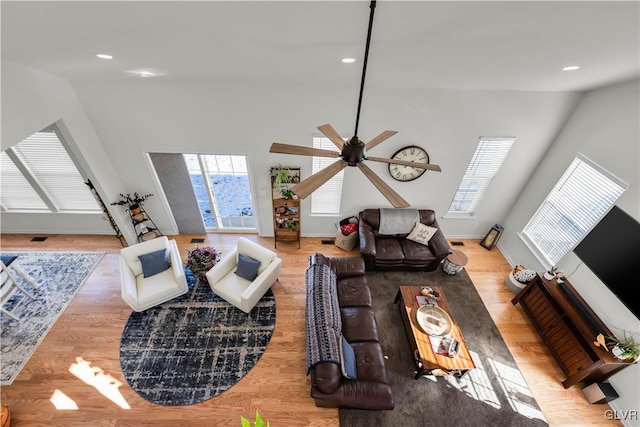 living area with light wood finished floors, baseboards, a ceiling fan, and recessed lighting