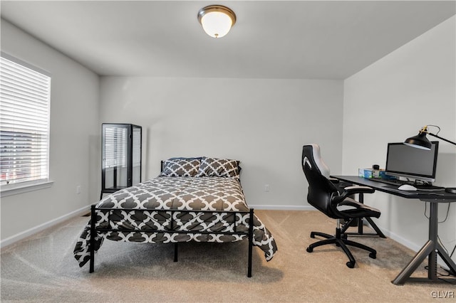 bedroom with light carpet and baseboards