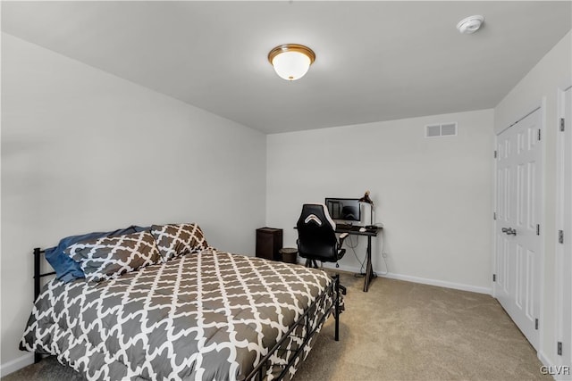 carpeted bedroom with visible vents and baseboards