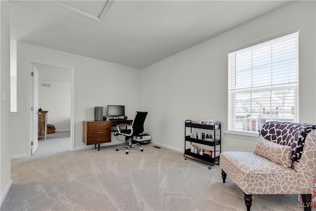 office area featuring light carpet, baseboards, and visible vents