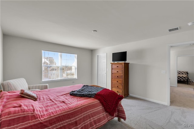 bedroom featuring light carpet, visible vents, and baseboards