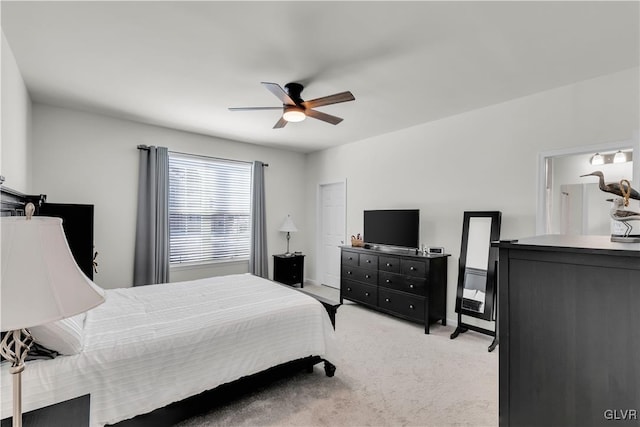 bedroom featuring a ceiling fan and light colored carpet