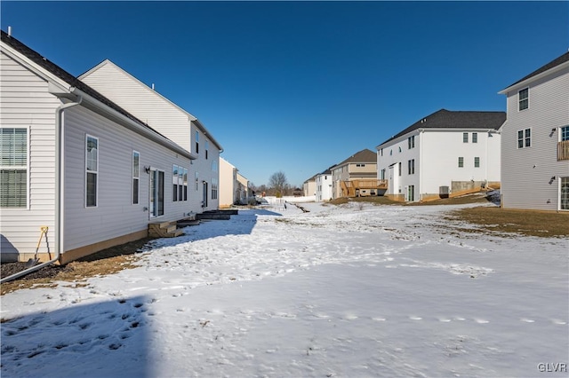 snowy yard with a residential view