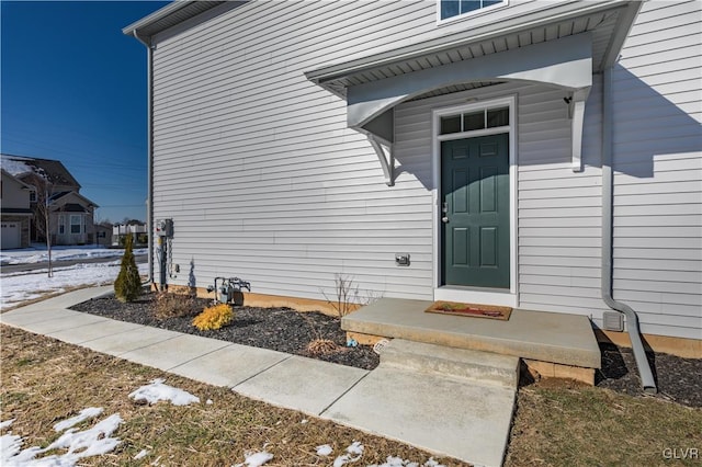 view of snow covered property entrance