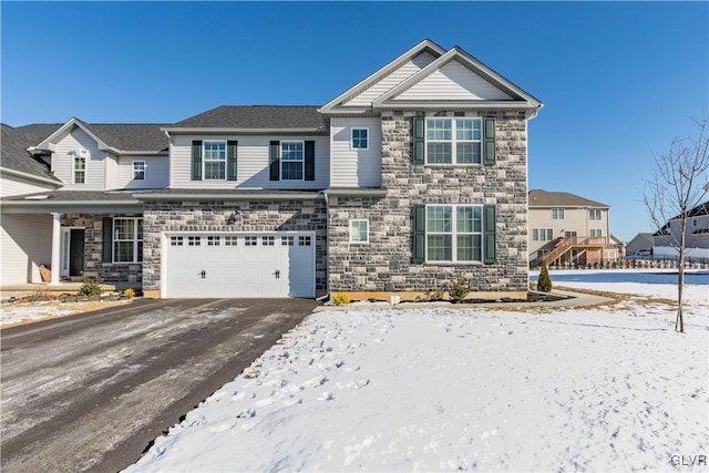 view of front of house with driveway, stone siding, an attached garage, and a residential view