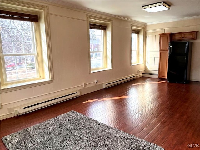 unfurnished room with ornamental molding, baseboard heating, and plenty of natural light