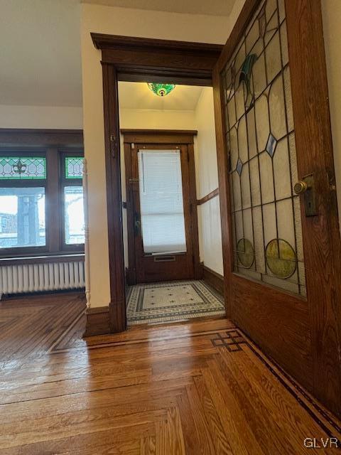 entryway featuring parquet floors and radiator heating unit