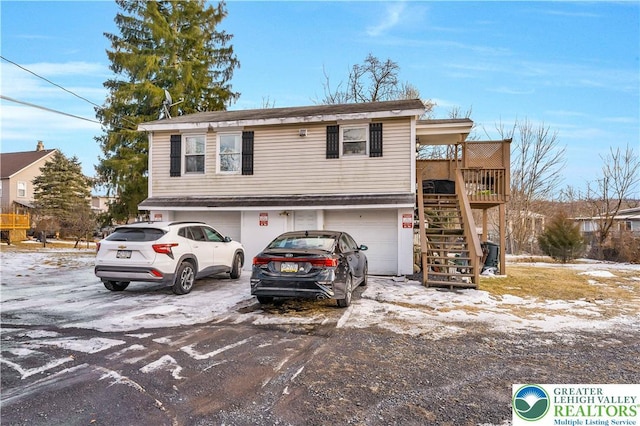 63 N 10th St, Stroudsburg, PA 18360 - view of front of property with a garage, stairs, and driveway