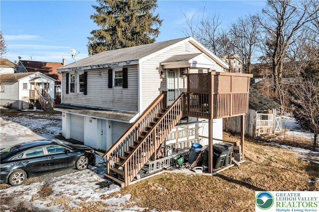 63 N 10th St, Stroudsburg, PA 18360 - view of front of property featuring a garage, stairway, and roof with shingles