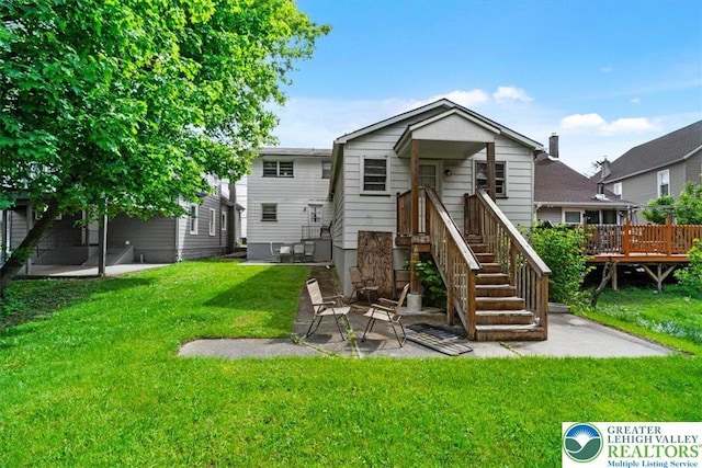 63 N 10th St, Stroudsburg, PA 18360 - back of property with a lawn, a deck, and a patio