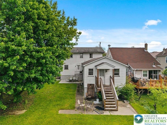 63 N 10th St, Stroudsburg, PA 18360 - back of property featuring a patio area, a yard, and a deck