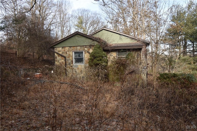 view of property exterior with stone siding