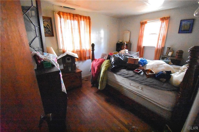 bedroom with dark wood finished floors