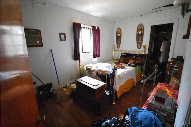 bedroom with dark wood-style flooring