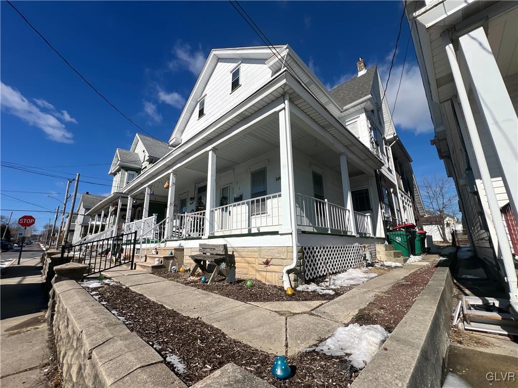 view of side of home with covered porch