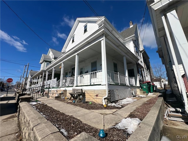 view of side of home with covered porch