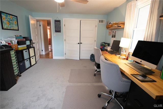 home office with light carpet, baseboards, visible vents, and ceiling fan