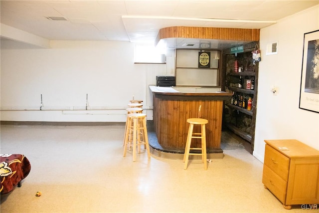 bar with light floors, visible vents, and a bar